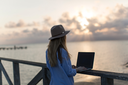 working at beach with laptop